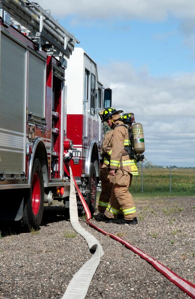 Airman 1st Class Graden Nichols, a firefighter assigned to the 5th Civil Engineer Squadron, prepares to begin training at the fire department training pit at Minot Air Force Base, N.D., Aug. 24, 2016. During the training, firefighters cannot have more than one fire going on at the same time. (U.S. Air Force photo/Airman 1st Class Jonathan McElderry)