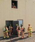 5th Civil Engineer Squadron firefighters enter the fire training building on Minot Air Force Base, N.D., Aug. 24, 2016. Firefighters are trained to enter burning buildings to put out fires while searching for any victims. (U.S. Air Force photo/Airman 1st Class Jonathan McElderry)