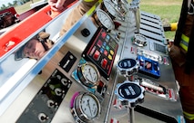 Airman 1st Class Graden Nichols, a firefighter assigned to the 5th Civil Engineer Squadron, controls the pump panel on a fire truck during a training exercise at the fire department training pit at Minot Air Force Base, N.D., Aug. 24, 2016. The pump panel controls how much water goes in and out of the hoses. (U.S. Air Force photo/Airman 1st Class Jonathan McElderry)