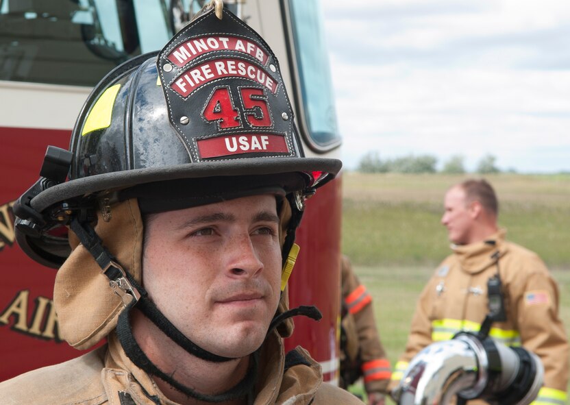 A firefighter with the 5th Civil Engineer Squadron just finished going into the fire training building at the fire department training pit at Minot Air Force Base, N.D., Aug. 24, 2016. Training allows each firefighter to stay current and to earn new certifications. (U.S. Air Force photo/Airman 1st Class Jonathan McElderry)