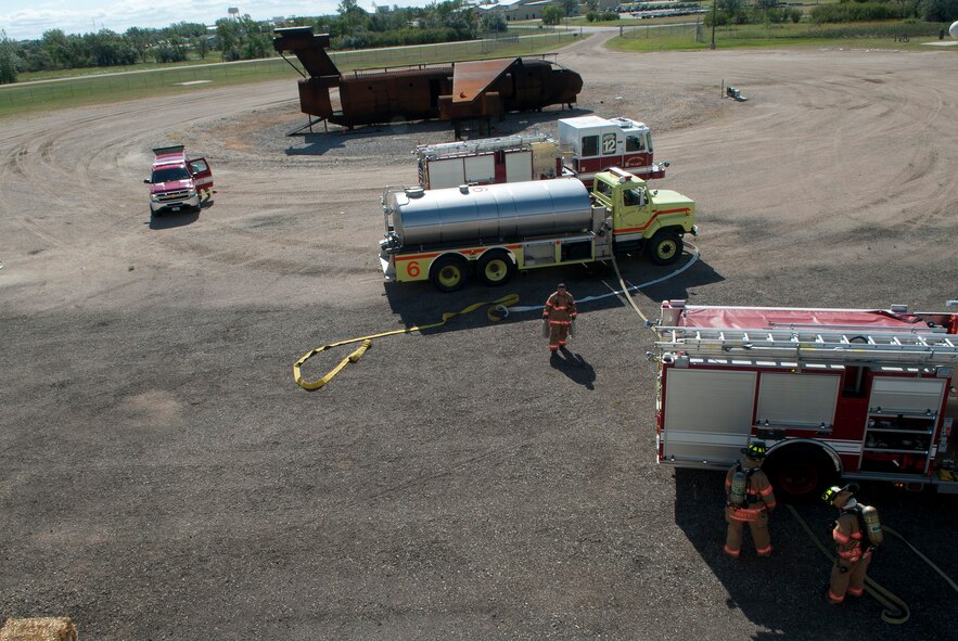 Firefighters with the 5th Civil Engineer Squadron arrive at the fire department training pit at Minot Air Force Base, N.D., Aug. 24, 2016. There are approximately 60 trained firefighters in the 5th CES. (U.S. Air Force photo/Airman 1st Class Jonathan McElderry)