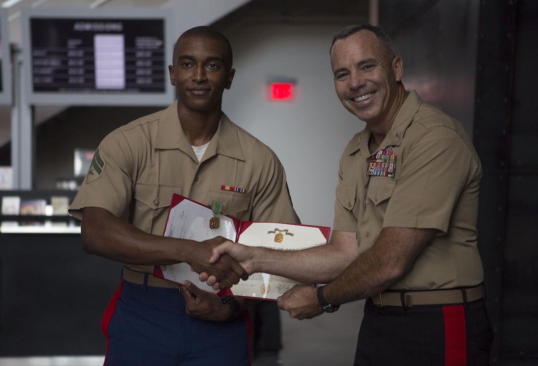Cpl. Justin J. Merritt an embarkation clerk with 4th Marine Division, Marine Forces Reserve, is awarded a Navy and Marine Corps Achievement Medal by Brig. Gen. Paul K. Lebidine, commanding general of 4th MarDiv, following the kick-off ceremony of the U.S. Marine Corps Centennial at the National World War II Museum in New Orleans, Aug. 26, 2016. Merritt was recognized as the 4th MarDiv Marine of the Year for his exemplary professionalism and his drive to go above and beyond while serving as an embarkation clerk with Marine Forces Reserve. 