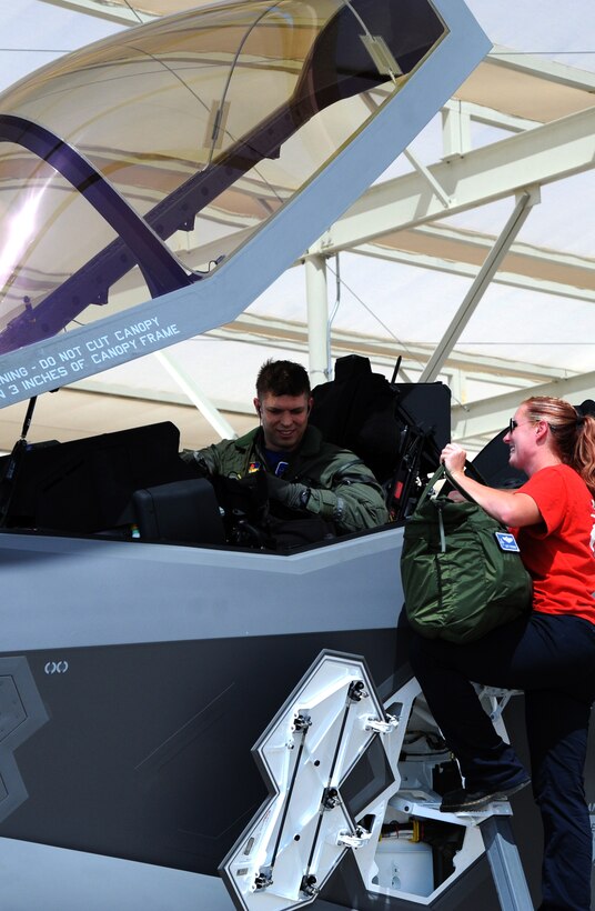 Maj.Matt Strongin, 62nd Fighter Squadron F-35 Lightning II pilot, is met by a 62nd Aircraft Maintenance Unit Airman Aug. 26, 2016, after landing the Air Force's 100th F-35. This milestone comes on the heels of the Air Force's announcement of the F-35's initial operational capability. (U.S. Air Force photo by Tech. Sgt. Luther Mitchell Jr)