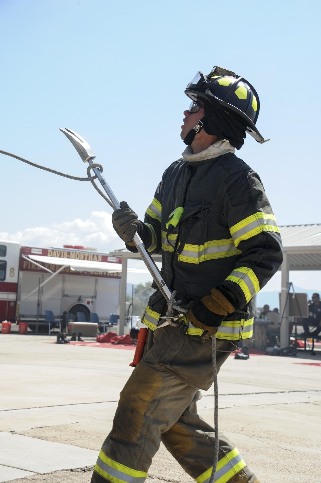 A firefighter from the Green Valley Fire District hoists a Halligan bar during live-fire training at Davis-Monthan Air Force Base, Ariz., Aug. 24, 2016. Members of the 355th Civil Engineer Squadron’s Fire and Emergency Services and the Green Valley Fire District participated in live-fire Class A training over the course of four days on D-M AFB’s fire training grounds. (U.S. Air Force photo by Airman 1st Class Mya M. Crosby)