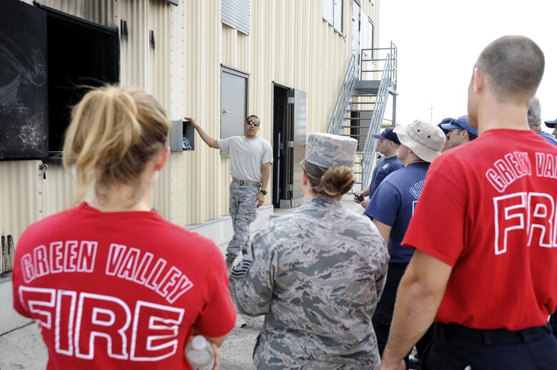 U.S. Air Force Staff Sgt. Eric Partlow, 355th Civil Engineer Squadron NCO in charge of training, briefs 355th CES and Green Valley firefighters before live-fire training at Davis-Monthan Air Force Base, Ariz., Aug. 26, 2016. Members of the 355th CES’s Fire and Emergency Services and the Green Valley Fire District participated in live-fire Class A training over the course of four days on D-M AFB’s fire training grounds. (U.S. Air Force photo by Airman 1st Class Mya M. Crosby)