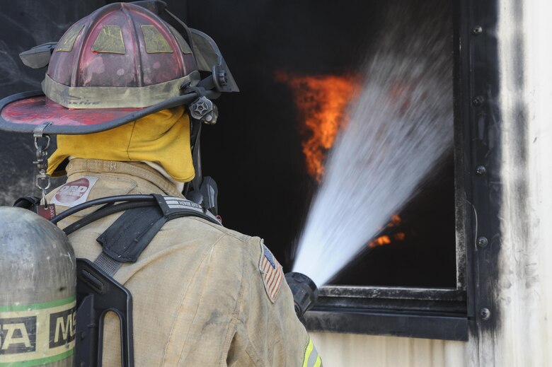 U.S. Air Force Staff Sgt. Eric Partlow, 355th Civil Engineer Squadron NCO in charge of training, regulates a fire during live-fire training at Davis-Monthan Air Force Base, Ariz., Aug. 26, 2016. Members of the 355th CES’s Fire and Emergency Services and the Green Valley Fire District participated in live-fire Class A training over the course of four days on D-M AFB’s fire training grounds. (U.S. Air Force photo by Airman 1st Class Mya M. Crosby)