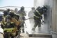 U.S. Airmen assigned to the 355th Civil Engineer Squadron and firefighters from Green Valley Fire District prepare to enter into a burn house at Davis-Monthan Air Force Base, Ariz., Aug. 24, 2016. Members of the 355th CES’s Fire and Emergency Services and the Green Valley Fire District participated in live-fire Class A training over the course of four days on D-M AFB’s fire training grounds. (U.S. Air Force photo by Airman 1st Class Mya M. Crosby)