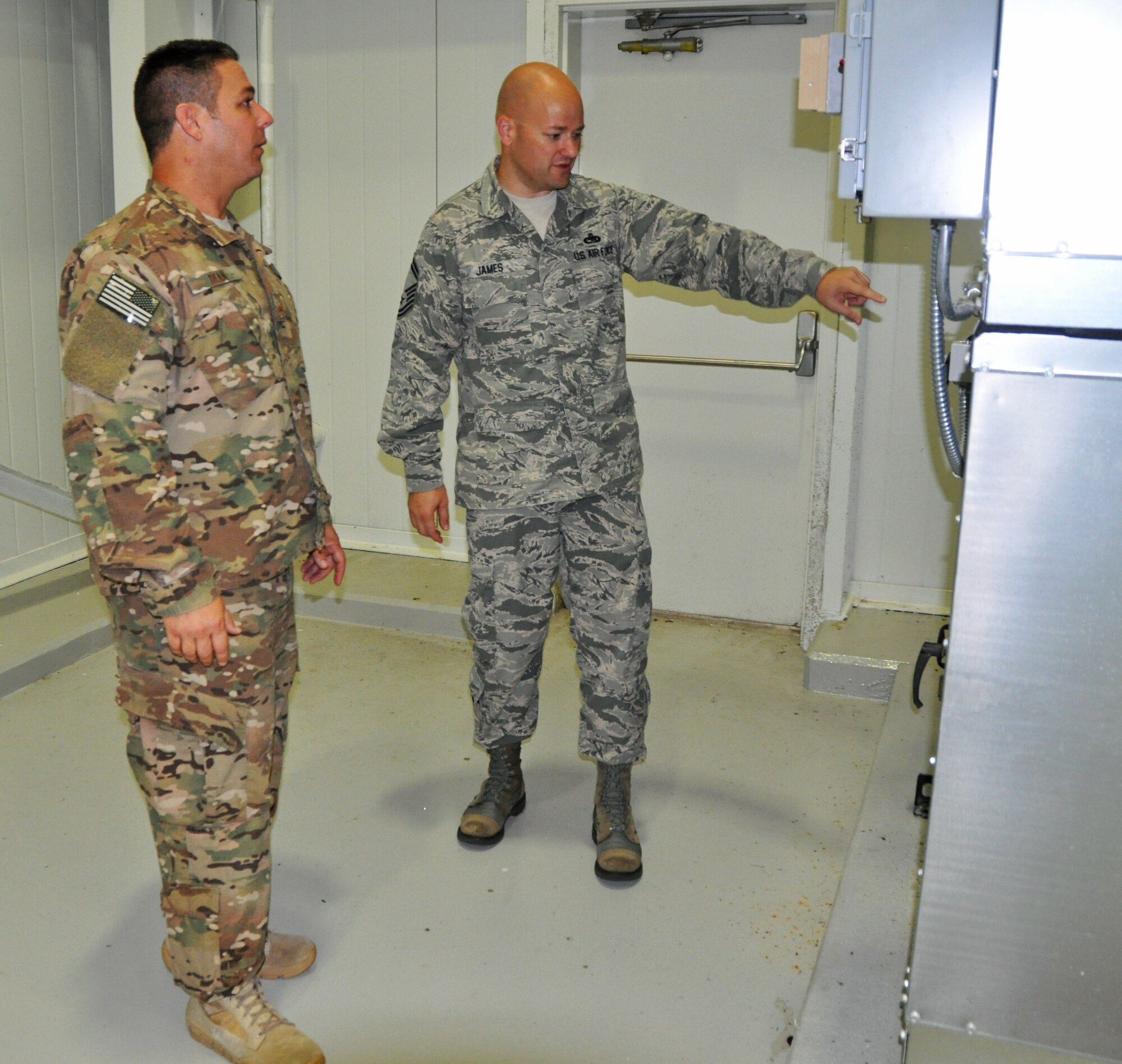 Senior Master Sgt. Trevor James, Air Force Special Operations Command Logistics Directorate superintendent, assesses features on an air handling system with Master Sgt. David Dean, 919th Special Operations Maintenance Squadron, in the fuel cell at Duke Field, Fla., Aug. 26, 2016 during the Site Activation Task Force Visit.  More than 100 functional experts from Air Force Special Operations Command, Air Force Reserve Command, 96th Test Wing (Eglin Air Force Base, Fla.) and 27th Special Operations Wing (Cannon AFB, N.M.) visited Duke Field Aug. 22-26, 2016 to study the impact of changes being made to the Non-Standard Aviation mission here. (U.S. Air Force photo/Dan Neely)