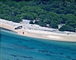 EAST FAYU ISLAND, Micronesia (Aug. 25, 2016) A pair of stranded mariners signal for help by writing "SOS" in the sand as a U.S. Navy P-8A Poseidon aircraft crew from Patrol Squadron (VP) 8 flies over in support of a Coast Guard search and rescue mission. (U.S. 7th Fleet area of operations. (U.S. Navy photo/Released)