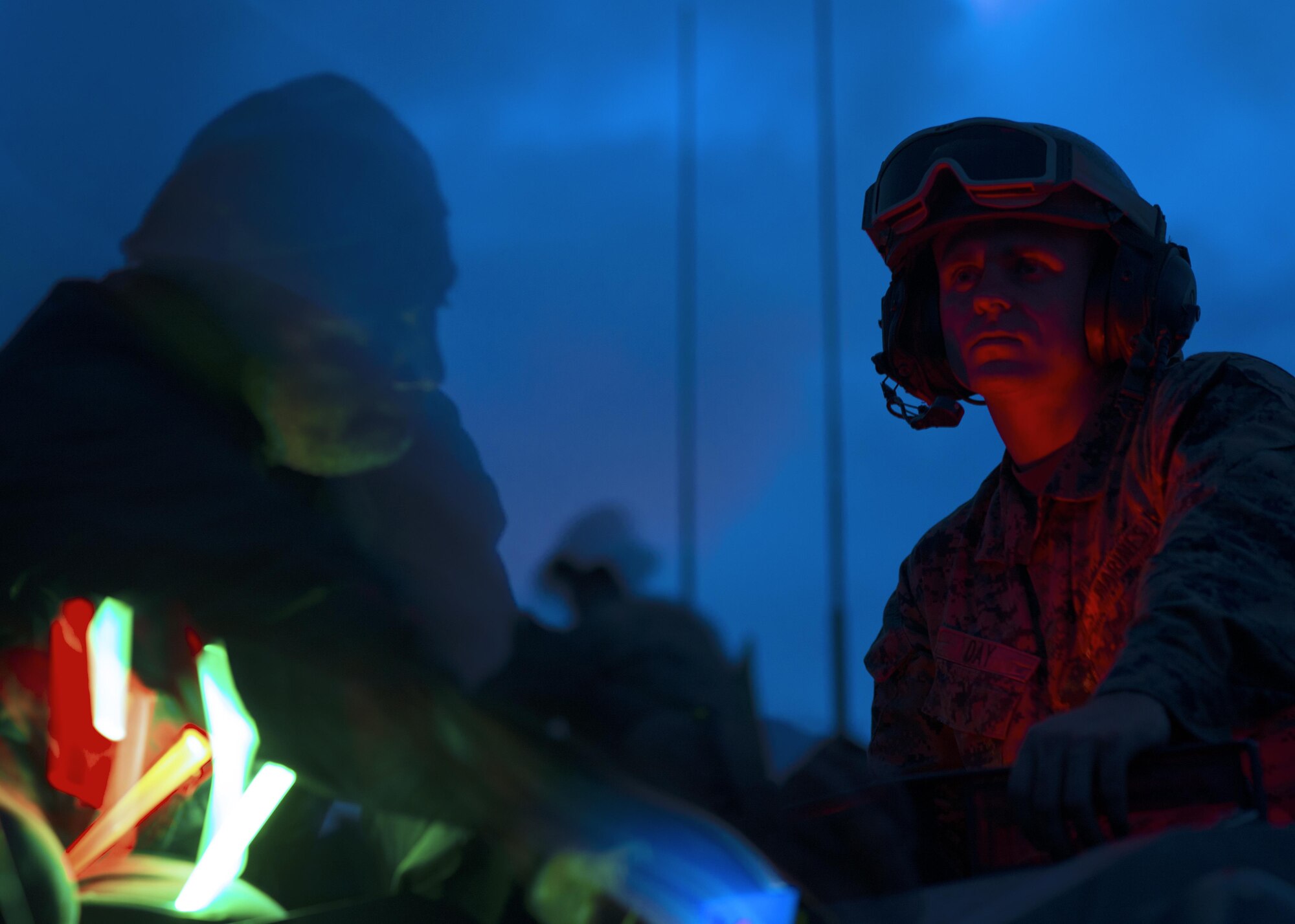 Mark Allen, instructor of the combat photography class, at Yokota Air Base, works in dramatic low-light conditions to get the photograph he wants of a Marine in a turret atop a light armored vehicle in a training area near Camp Fuji, Japan, Aug. 24, 2016. Allen enjoys the challenge of taking photographs at night. (U.S. Air Force photo by Airman 1st Class Donald Hudson/Released)