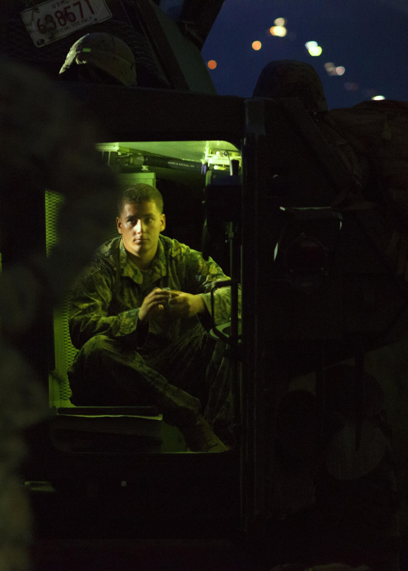 A Marine sits in the back of a light-armored vehicle resting while listing to the platoon leaders make plans for sleeping arrangements for the night at a training area near Camp Fuji, Japan, Aug. 24, 2016. The Marines were training throughout the day and night on combat mobility techniques in light-armored vehicles. (U.S. Air Force photo by Airman 1st Class Donald Hudson/Released)