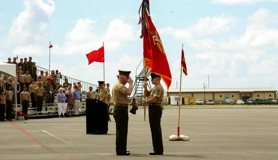 Sgt. Maj. Paul G. McKenna, the sergeant major of U.S. Marine Corps Forces, Pacific, prepares to hand  Lt. Gen. John A. Toolan the colors during a change of command ceremony at Marine Corps Base Hawaii, Aug. 26, 2016. During the ceremony, Lt. Gen. John A. Toolan relinquished command of MARFORPAC to Lt. Gen. David H. Berger. 