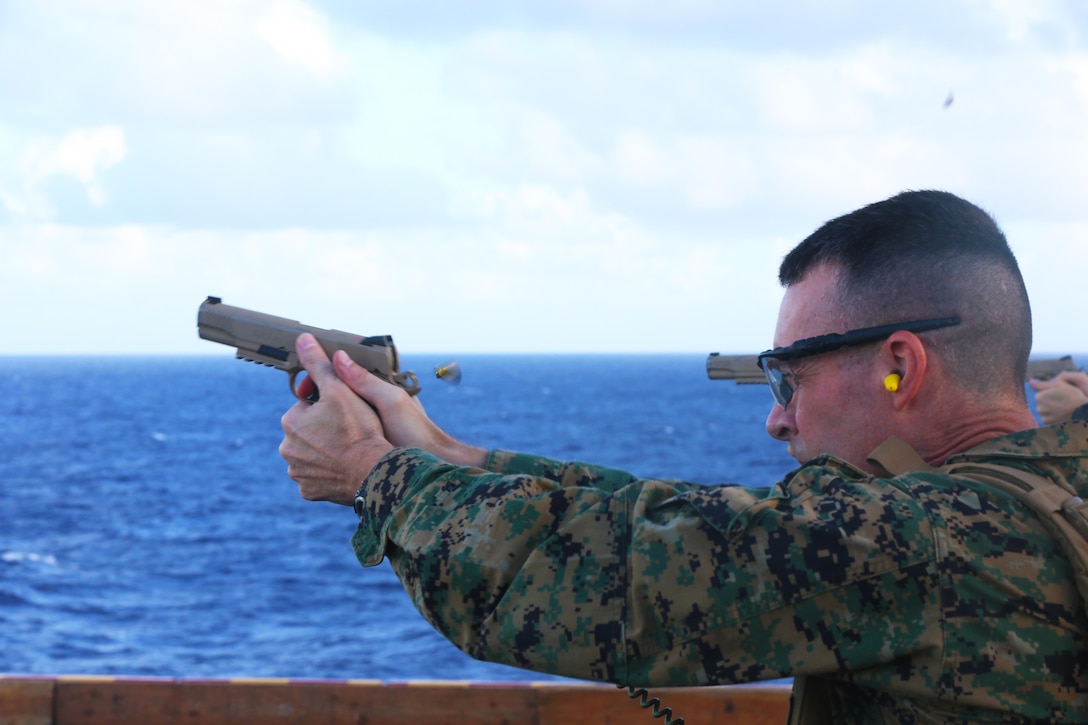 ABOARD USS BONHOMME RICHARD (LHD-6), At Sea (Aug. 26, 2016) – Col. Tye R. Wallace, commanding officer of the 31st Marine Expeditionary Unit, fires an M1911 .45-caliber pistol during live-fire training aboard the USS Bonhomme Richard (LHD-6), at sea, Aug. 26, 2016. The 31st MEU combines air-ground-logistics into a single unit with one commander, and is task-organized to address a wide variety of military operations in the Asia-Pacific region – from force projection and maritime security to humanitarian assistance and disaster relief in cooperation with host countries and partner militaries. (U.S. Marine Corps photo by Lance Cpl. Jay A. Parks/ Released)