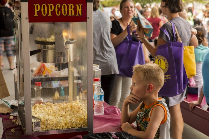 A student from Matthew C. Perry Elementary School waits for popcorn during the Back to School Bash at Marine Corps Air Station Iwakuni, Japan, Aug. 26, 2016. This school year will mark the last first day of school for students at the old M.C. Perry buildings. Elementary school students enjoyed concessions and games, posed for photos with McGruff, the Provost Marshal’s Office’s mascot, toured a fire truck and PMO police cruiser before receiving their new teacher assignments and touring the school. (U.S. Marine Corps photo by Lance Cpl. Aaron Henson)