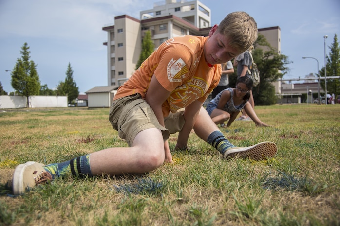A student from Matthew C. Perry High School participates in mega twister during the Back to School Bash at Marine Corps Air Station Iwakuni, Japan, Aug. 26, 2016. This school year will mark the last first day of school for students at the old M.C. Perry buildings. (U.S. Marine Corps photo by Lance Cpl. Aaron Henson)
