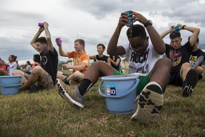 Students from Matthew C. Perry High School play pass the water during the Back to School Bash at Marine Corps Air Station Iwakuni, Japan, Aug. 26, 2016. This school year will mark the last first day of school for students at the old M.C. Perry buildings. The high school students participated in activities such as the wacky tourist, mega twister, dizzy izzy, the frozen t-shirt challenge, a hula hoop relay and a water balloon fight. (U.S. Marine Corps photo by Lance Cpl. Aaron Henson)