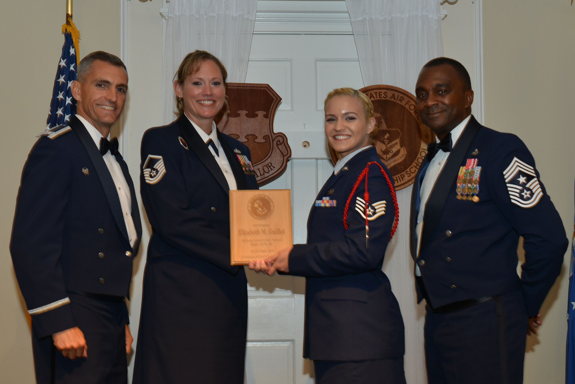 U.S. Air Force Staff Sgt. Elizabeth Guillot, 5th Intelligence squadron, receives the Senior Master Sgt. David B. Reid Airman Leader Ship School Commandant’s Award from Master Sgt. Lindsey Wolf, 20th Force Support Squadron ALS commandant, during the ALS Class 16-6 graduation at Shaw Air Force Base, S.C., Aug. 25, 2016. The Commandant’s Award is given to the student who most exemplifies professional military qualities as chosen by their peers, the primary instructors, and the ALS commandant. (U.S. Air Force photo by Airman 1st Class Destinee Sweeney)