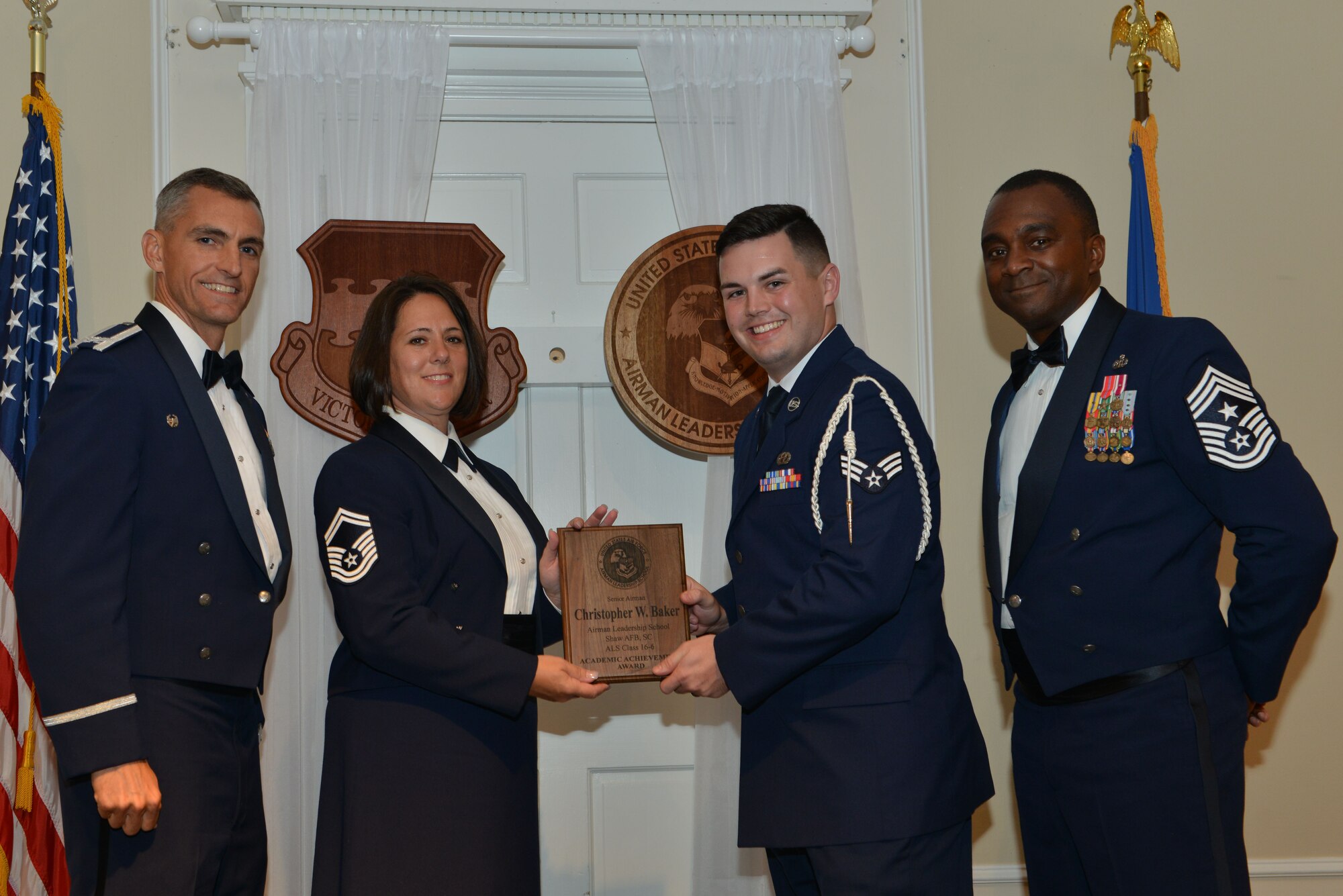 U.S. Air Force Senior Airman Christopher Baker, 31st Intelligence Squadron, receives the Senior Master Sgt. David B. Reid Airman Leadership School Academic Achievement award from Senior Master Sgt. Valerie Mullens, 609th Air Communications Squadron operations flight chief, during the ALS Class 16-6 graduation at Shaw Air Force Base, S.C., Aug. 25, 2016. This award is given to the student with the highest point total. (U.S. Air Force photo by Airman 1st Class Destinee Sweeney)