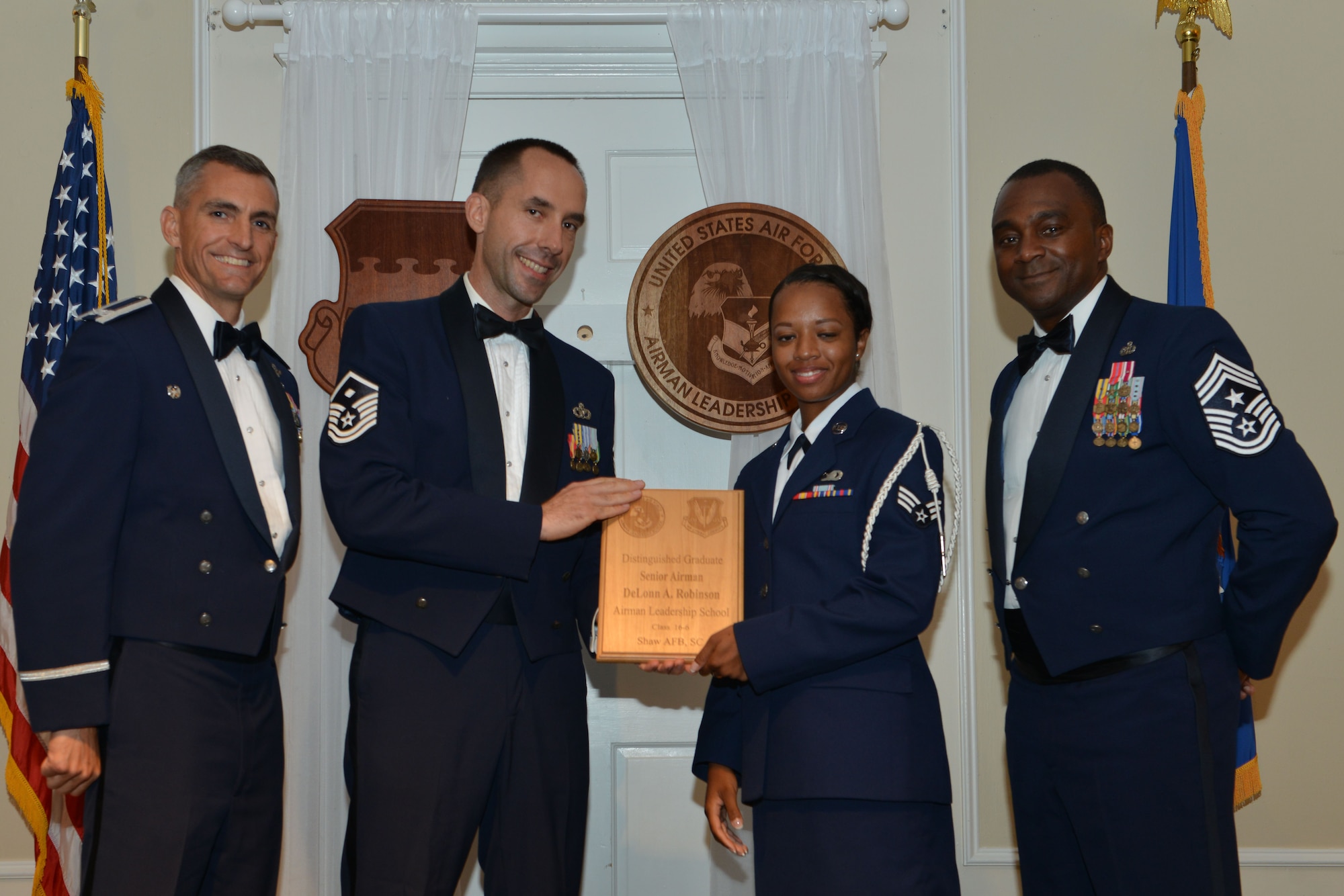U.S. Air Force Senior Airman DeLonn Robinson, 5th Intelligence Squadron, receives a distinguished graduate award for the Senior Master Sgt. David B. Reid Airman Leadership School Class 16-6 from Master Sgt. Robert Finton, 20th Operations Support Squadron first sergeant, at Shaw Air Force Base, S.C., Aug. 25, 2016. The distinguished graduate awards are given to the top 10 percent of the class for total point accumulation. (U.S. Air Force photo by Airman 1st Class Destinee Sweeney)