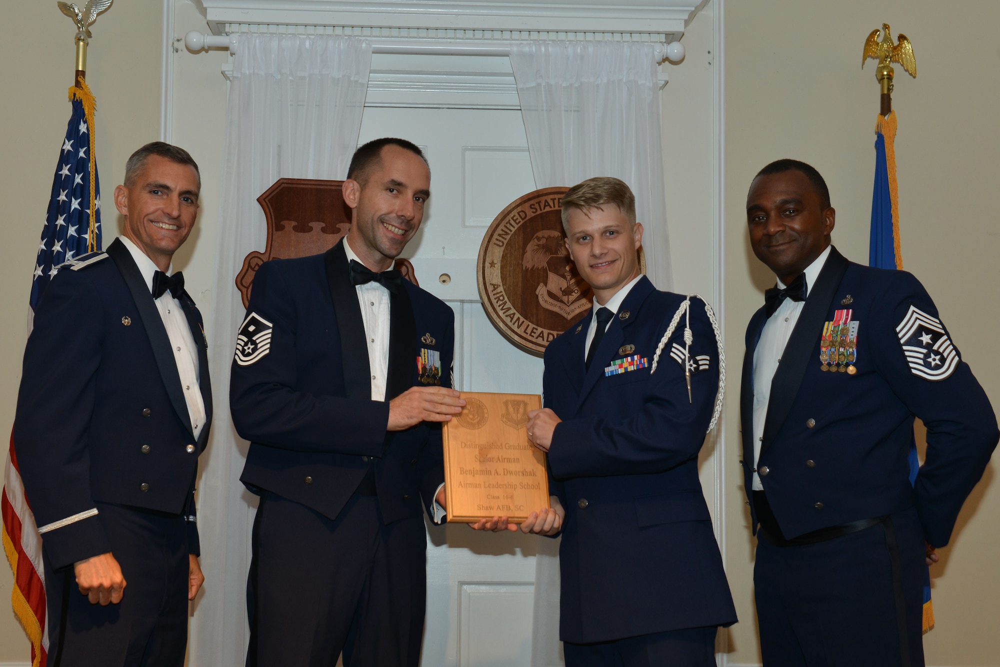 U.S. Air Force Senior Airman Benjamin Dworshak, 3rd Intelligence Squadron, receives a distinguished graduate award for the Senior Master Sgt. David B. Reid Airman Leadership School Class 16-6 from Master Sgt. Robert Finton, 20th Operations Support Squadron first sergeant, at Shaw Air Force Base, S.C., Aug. 25, 2016. The distinguished graduate awards are given to the top 10 percent of the class for total point accumulation. (U.S. Air Force photo by Airman 1st Class Destinee Sweeney)
