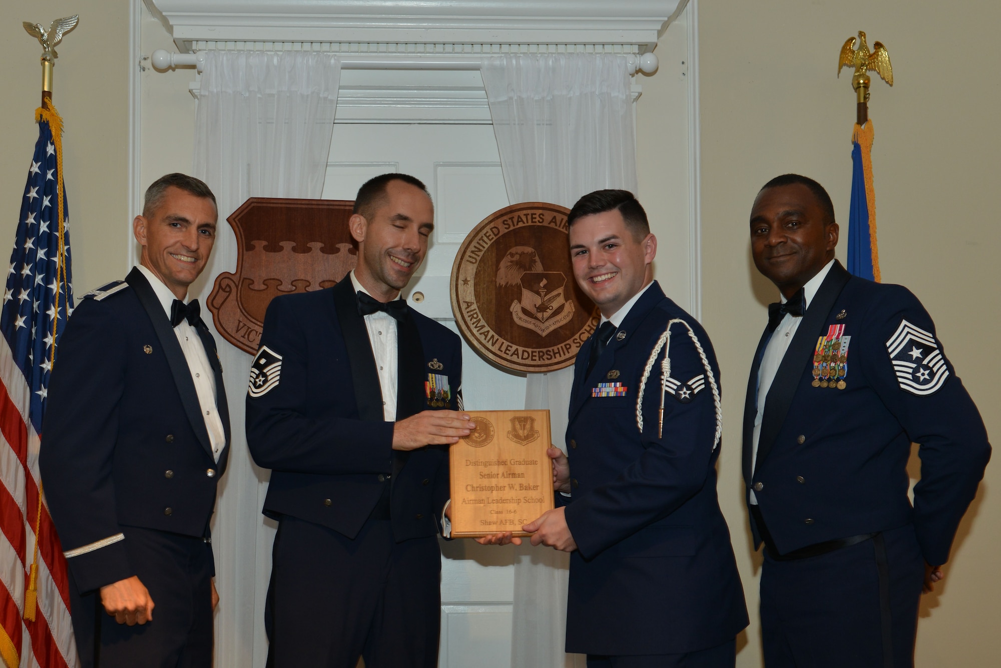 U.S. Air Force Senior Airman Christopher Baker, 31st Intelligence Squadron, receives a distinguished graduate award for the Senior Master Sgt. David B. Reid Airman Leadership School Class 16-6 from Master Sgt. Robert Finton, 20th Operations Support Squadron first sergeant, at Shaw Air Force Base, S.C., Aug. 25, 2016. The distinguished graduate awards are given to the top 10 percent of the class for total point accumulation. (U.S. Air Force photo by Airman 1st Class Destinee Sweeney)