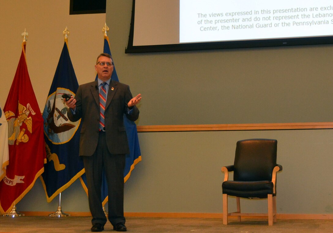 Lt. Col. Douglas Etter, an Army National Guard chaplain, speaks to Troop Support employees to help them better understand PTSD during a workshop Aug. 25. 