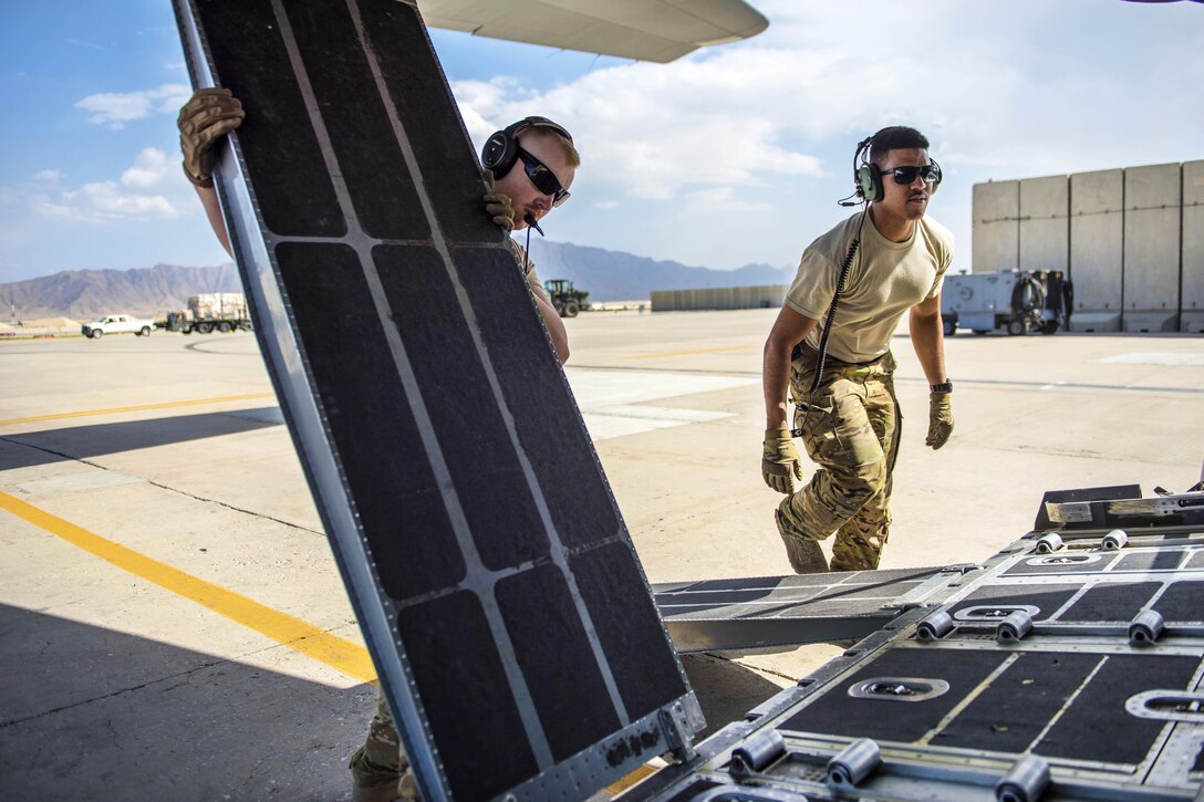 Air Force Staff Sgt. Dallion Richards, right, and Senior Airman Andrew Garrett lower the cargo vehicle ramps on a C-130J Super Hercules aircraft at Bagram Airfield, Afghanistan, Aug. 19, 2016. Richards and Garrett are loadmasters assigned to the 774th Expeditionary Airlift Squadron. Air Force photo by Senior Airman Justyn M. Freeman