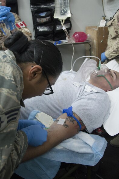 A member of the 386th Expeditionary Medical Group administers intravenous therapy during an medical exercise with Canadian forces Aug. 4, 2016 at an undisclosed location in Southwest Asia. (U.S. Air Force photo by Master Sgt. Anika Jones/Released)