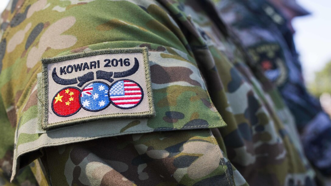 U.S. Marines and soldiers, Australian Army soldiers, and People’s Liberation Army soldiers receive a patch during Exercise Kowari’s opening ceremony at Larrakeyah Barracks, Northern Territory, Australia, August 26, 2016. The purpose of Exercise Kowari is to enhance the United States, Australia, and China’s friendship and trust, through trilateral cooperation in the Asia-Pacific and Indian Ocean Rim regions.