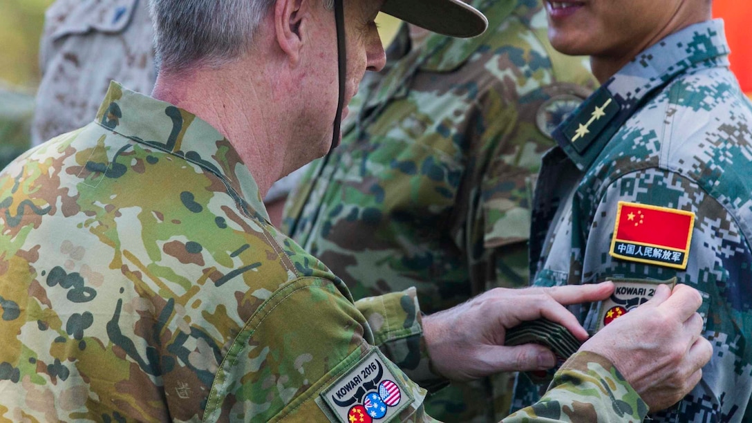 Brigadier Damian Cantwell, the Exercise Kowari commander, gives a patch to all the participants of Exercise Kowari at Larrakeyah Barracks, Northern Territory, Australia, August 26, 2016. The purpose of Exercise Kowari is to enhance the United States, Australia, and China’s friendship and trust, through trilateral cooperation in the Asia-Pacific and Indian Ocean Rim regions.