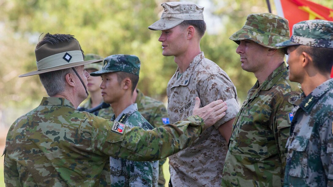 Brigadier Damian Cantwell, the Exercise Kowari commander, gives a patch to all the participants of Exercise Kowari at Larrakeyah Barracks, Northern Territory, Australia, August 26, 2016. The purpose of Exercise Kowari is to enhance the United States, Australia, and China’s friendship and trust, through trilateral cooperation in the Asia-Pacific and Indian Ocean Rim regions.