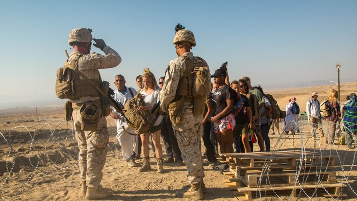 Marines with Special Purpose Marine Air Ground Task Force, Crisis Response, Central Command, interact with role-players during a non-combatant evacuation operation exercise at Range 220, a military operations on urbanized terrain facility, at Marine Corps Air Ground Combat Center, Twentynine Palms, Calif., Aug. 24, 2016.