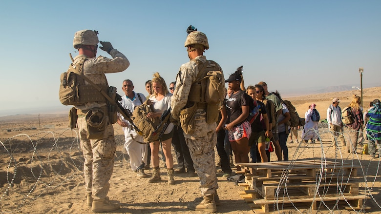 Marines with Special Purpose Marine Air Ground Task Force, Crisis Response, Central Command, interact with role-players during a non-combatant evacuation operation exercise at Range 220, a military operations on urbanized terrain facility, at Marine Corps Air Ground Combat Center, Twentynine Palms, Calif., Aug. 24, 2016.