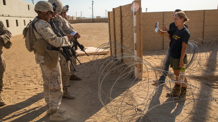 Marines with Special Purpose Marine Air Ground Task Force, Crisis Response, Central Command, interact with role-players during a non-combatant evacuation operation exercise at Range 220, a military operations on urbanized terrain facility, at Marine Corps Air Ground Combat Center, Twentynine Palms, Calif., Aug. 24, 2016.
