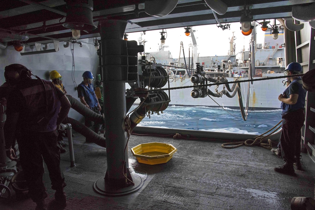 Sailors aboard the aircraft carrier USS Dwight D. Eisenhower prepare to seat a fuel probe in fueling station 13 during a replenishment-at-sea with the fast combat support ship USNS Arctic in the Persian Gulf, Aug. 19, 2016. Navy photo by Petty Officer 2nd Class J. E. Veal