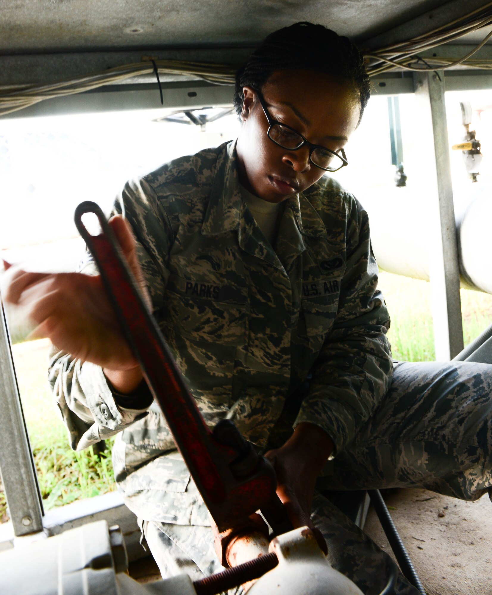 Senior Brittany Parks, 2nd Civil Engineer Squadron heating ventilation and air condition technician, closes a valve to the suction line of an HVAC system at Barksdale Air Force Base, La., Aug. 23, 2016. The suction line must be closed off so that refrigerant can be drained from the compressor without draining the whole unit. (U.S. Air Force photo/Senior Airman Luke Hill)