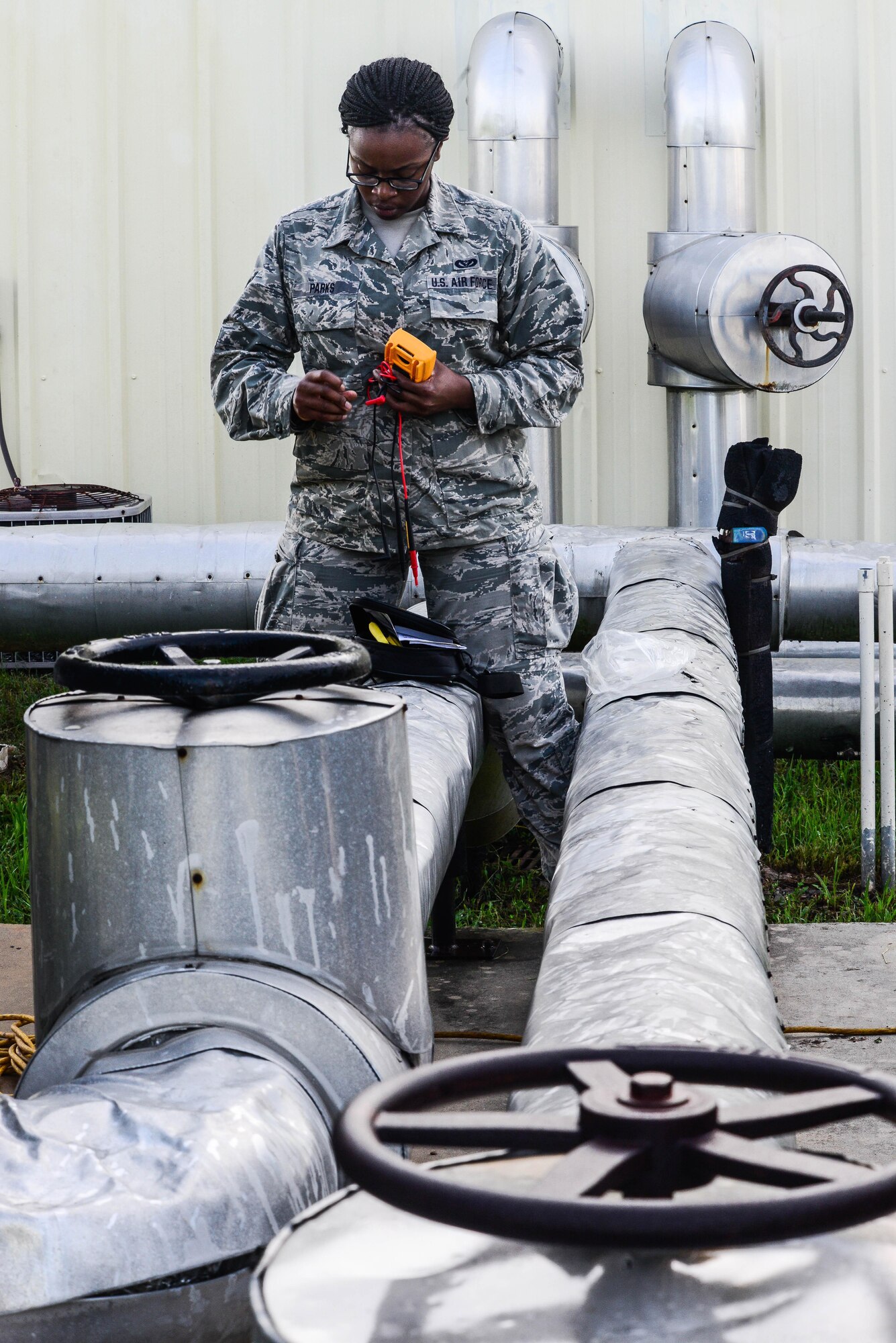 Senior Airman Brittany Parks, 2nd Civil Engineer Squadron heating ventilation and air condition technician, organizes equipment needed to do maintenance on an HVAC unit at Barksdale Air Force Base, La., Aug. 23, 2016. HVAC systems at Barksdale are put through a lot of stress because of the climate and therefore are constantly needing to be updated and repaired. (U.S. Air Force photo/Senior Airman Luke Hill)