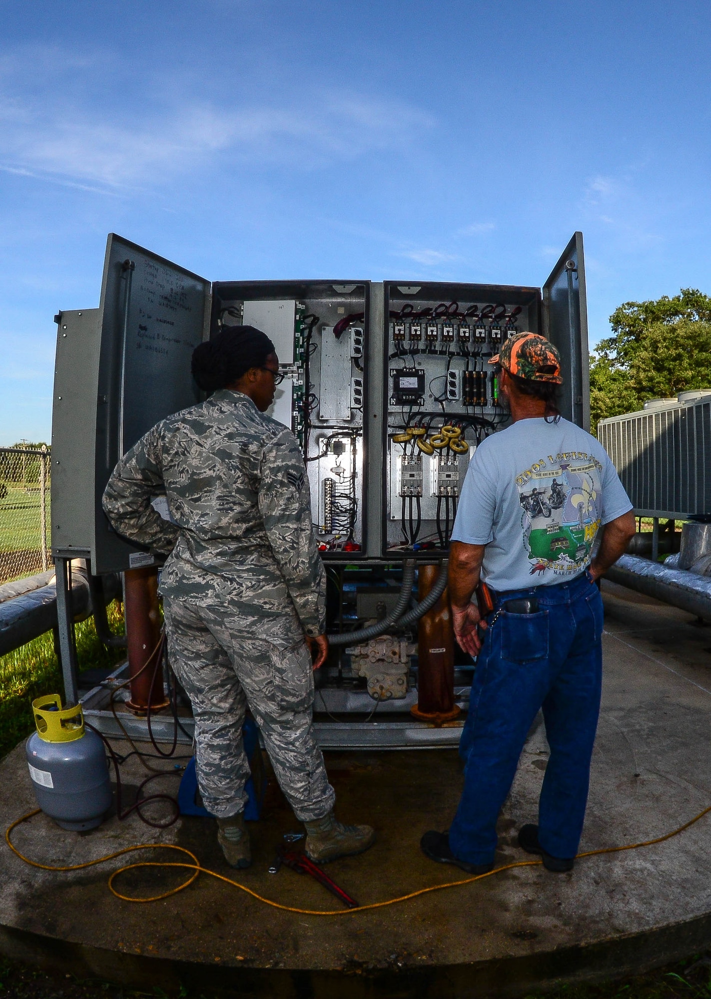 Senior Airman Brittany Parks, 2nd Civil Engineer Squadron heating ventilation and air condition technician and Jimmy Beattie, 2nd CES HVAC civilian, perform maintenance on an HVAC unit at Barksdale Air force Base, La., Aug. 23, 2016. Providing a comfortable work environment prevents overheating personnel and systems, and allows Airmen to work longer and more efficiently. (U.S. Air Force photo/Senior Airman Luke Hill)