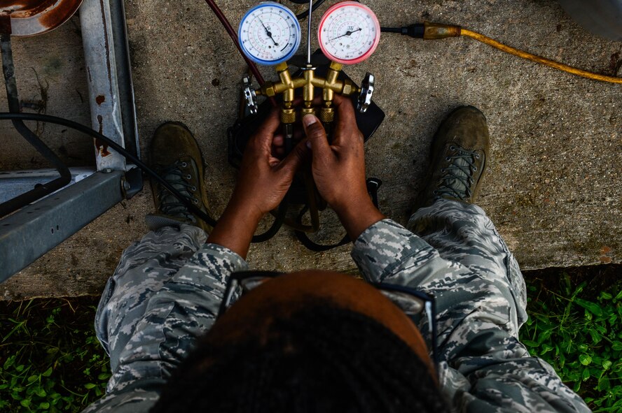 Senior Airman Brittany Parks, 2nd Civil Engineer Squadron heating ventilation and air condition technician, monitors a pressure valve connected to an HVAC unit at Barksdale Air Force Base, La., Aug 23, 2016. HVAC Airmen also maintain units which cool servers running Barksdale’s communications. (U.S. Air Force photo/Senior Airman Luke Hill)