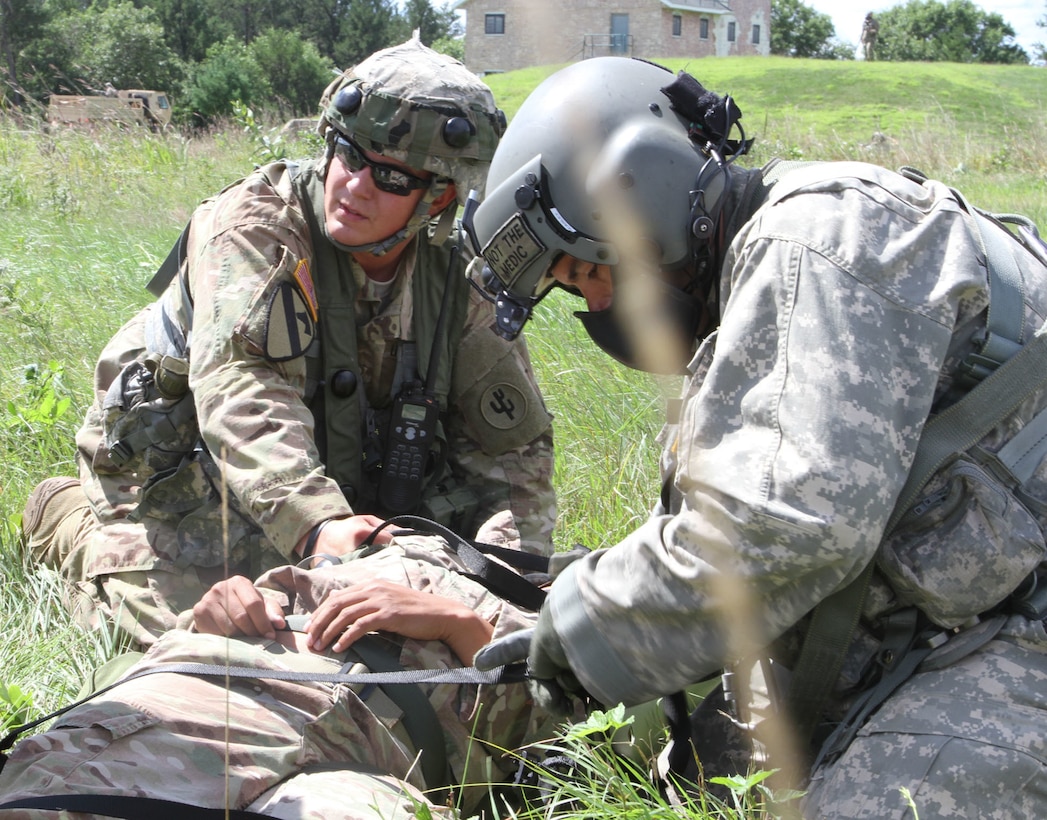 FORT MCCOY, Wis -- Army Reserve Soldiers from the 459th Transportation Company out of Springsfield, Mo., and F Company, 1st Battalion, 214th Aviation Regiment out of Jonestown, Pa., secure straps on a simulated casualty during Exercise Global Medic at Fort McCoy, Wis., on Aug. 21, 2016. Global Medic is an inter-service training event that develops and evaluates the collective skills of Army Reserve Soldiers and other service members in a collaborative environment. (U.S. Army Reserve photo by Spc. Christopher A. Hernandez, 345th Public Affairs Detachment)