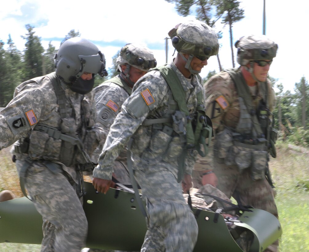FORT MCCOY, Wis -- Army Reserve Soldiers from the 459th Transportation Company out of Springsfield, Mo., and F Company, 1st Battalion, 214th Aviation Regiment out of Jonestown, Pa., lift a simulated casualty and prepare for air medical evacuation during Exercise Global Medic at Fort McCoy, Wis., on Aug. 21, 2016. Global Medic is an inter-service training event that develops and evaluates the collective skills of Army Reserve Soldiers and other service members in a collaborative environment. (U.S. Army Reserve photo by Spc. Christopher A. Hernandez, 345th Public Affairs Detachment)