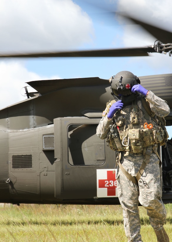FORT MCCOY, Wis -- An Army Reserve Soldier from F Company, 1st Battalion, 214th Aviation Regiment out of Jonestown, Pa., exits a UH-60 Blackhawk helicopter during Exercise Global Medic at Fort McCoy, Wis., on Aug. 21, 2016. Global Medic is an inter-service training event that develops and evaluates the collective skills of Army Reserve Soldiers and other service members in a collaborative environment. (U.S. Army Reserve photo by Spc. Christopher A. Hernandez, 345th Public Affairs Detachment)