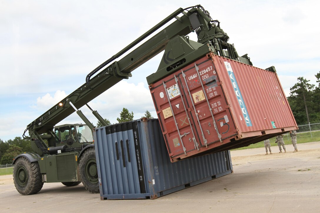 FORT McCOY, WISCONSIN — Engineers with the U.S. Army Reserve’s 86th Training Division manuevers and rearranges CONEX shipping containers while competing in a ‘CONEX Rodeo’ during CSTX 86-16-03 at Ft. McCoy, Wisconsin, August 17, 2016. Safety is the first priority during the CONEX Rodeo, with competitors attempting to re-stack the containers in the least amout of time. CSTX 86-16-03 is the 84th Training Command’s third and final Combat Support Training Exercise of the year (U.S. Army photo by Staff Sgt. Scott Griffin/Released)