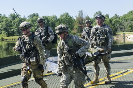 Army Reserve soldiers with the 86th Training Division evacuate a simulated casualty for medical treatment across a floating bridge emplaced by 86th TD engineers at Ft. McCoy, Wisconsin, August 17, 2016, during CSTX 86-16-03. CSTX 86-16-03 is the 84th Training Command’s third and final Combat Support Training Exercise of the year (U.S. Army photo by Staff Sgt. Scott Griffin/Released)