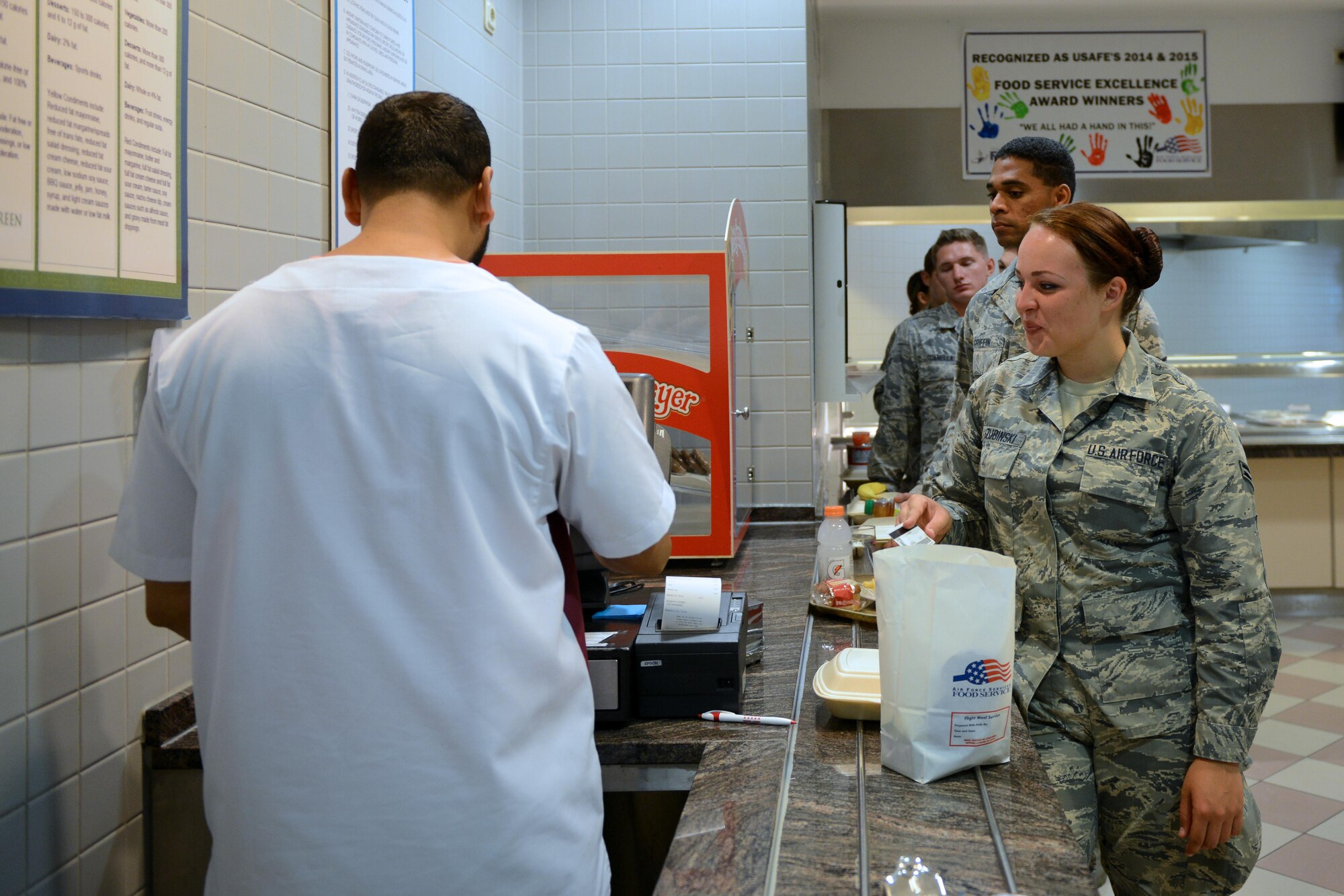 Airmen line up at the register at the Rheinland Inn Dining Facility, Aug. 29, 2016, Ramstein Air Base, Germany. Airmen and employees at the Rheinland Inn have been recognized as the United States Air Forces in Europe Food Service Excellence Award winners in 2014 and 2015. (U.S. Air Force photo/ Airman 1st Class Joshua Magbanua)
