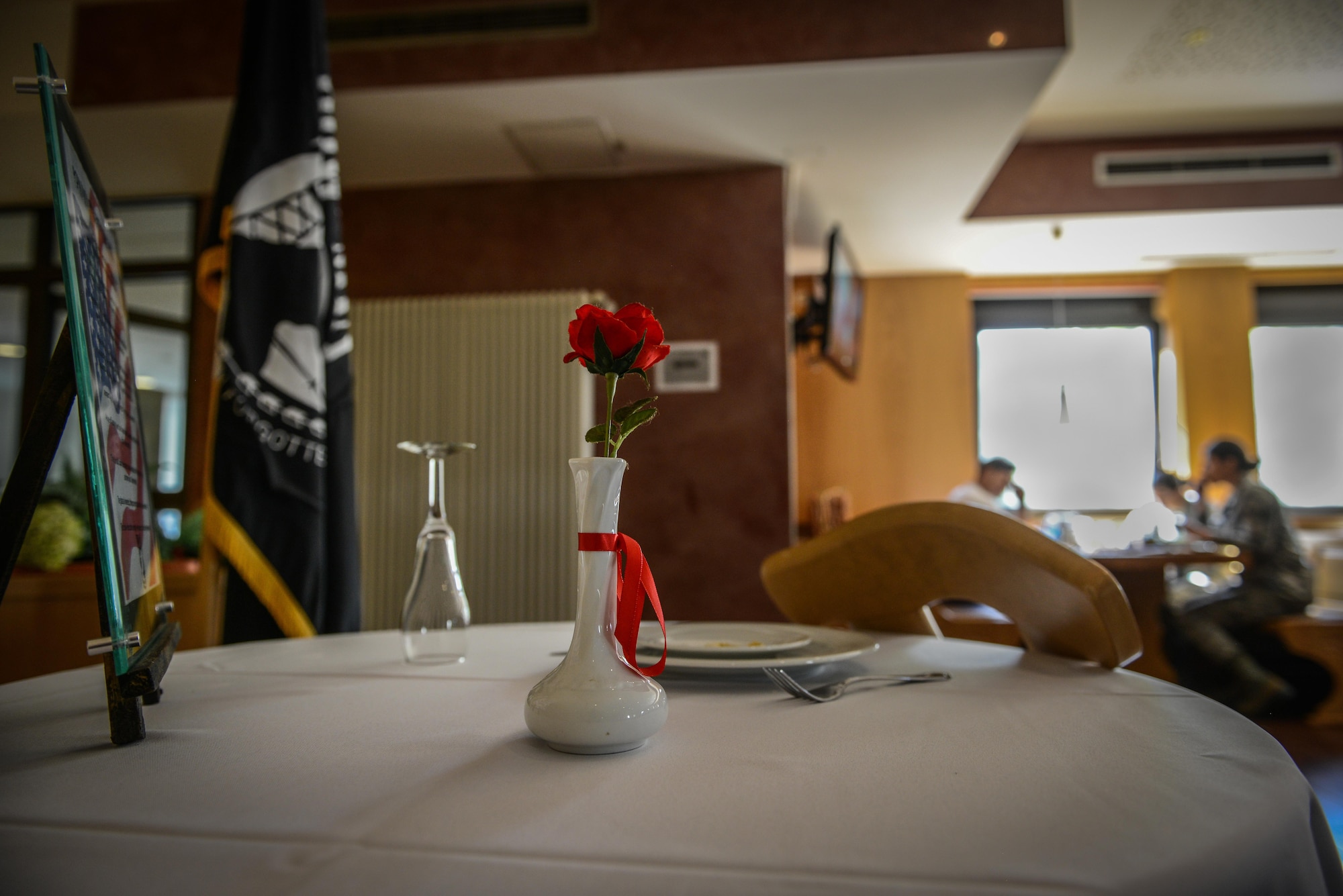 A prisoner of war-missing in action table is on display at the Rheinland Inn Dining Facility, Aug. 29, 2016, Ramstein Air Base, Germany. The empty table represents U.S. military members who have not been able to return home. (U.S. Air Force photo/ Airman 1st Class Joshua Magbanua)