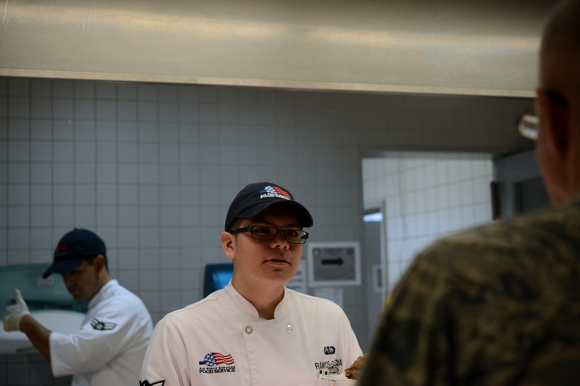 Airman Saul Ramos Garcia Jr., 786th Force Support Squadron food service apprentice, serves customers at the Rheinland Inn Dining Facility, Aug. 29, 2016, Ramstein Air Base, Germany. The Rheinland Inn serves approximately 700 customers a day. (U.S. Air Force photo/ Airman 1st Class Joshua Magbanua)