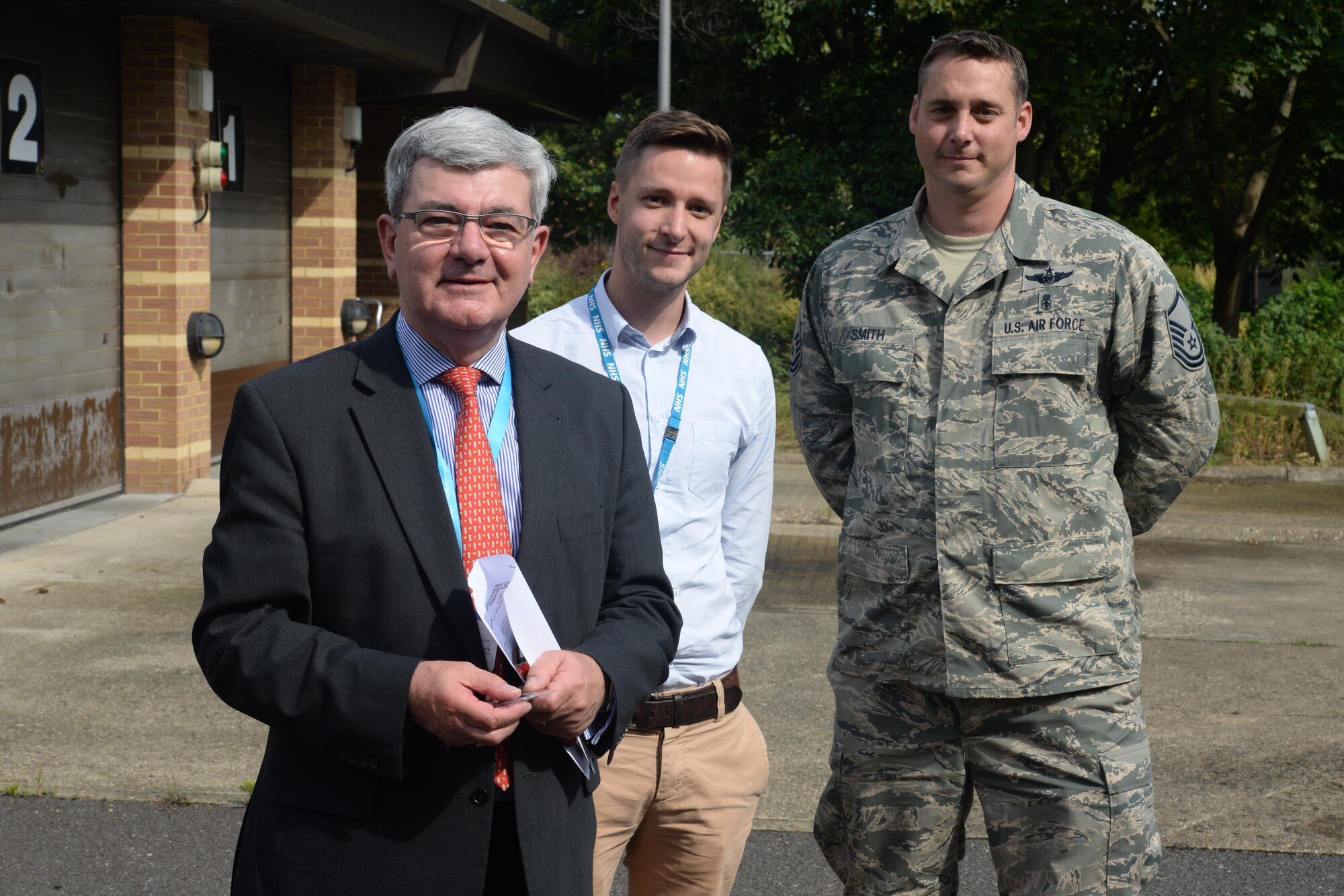 Sir Keith Pearson, left, the National Health Service’s chairman of Health Education England, poses for a photo with Matthew Friend, Southwest Health and Education England Stakeholder, and U.S. Air Force Master Sgt. Haven Smith, 48th Emergency Services Flight Chief at Royal Air Force Lakenheath, England, Aug. 25, 2016. Pearson visited to see how Liberty medics train. (U.S. Air Force photo/Airman 1st Class Eli Chevalier) 