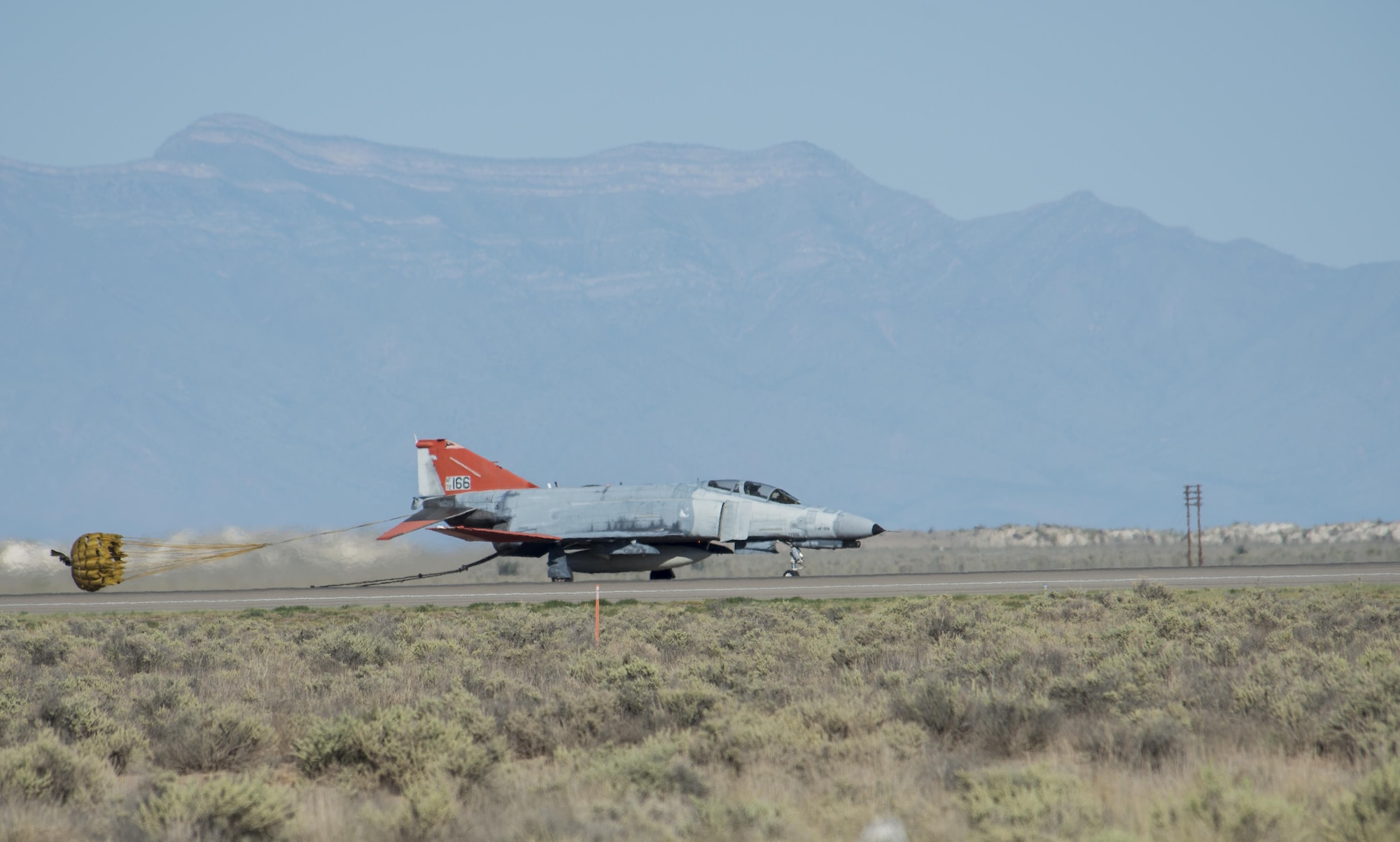 A QF-4 Phantom returns to Holloman Air Force Base after supporting an F-35 Lightning II mission in the skies above White Sands Missile Range, N.M. on Aug. 17. During the mission, an unmanned QF-4 served its primary function as an aerial target, while a manned QF-4 trailed to ensure mission success. (U.S. Air Force photo by Airman 1st Class Randahl J. Jenson) 