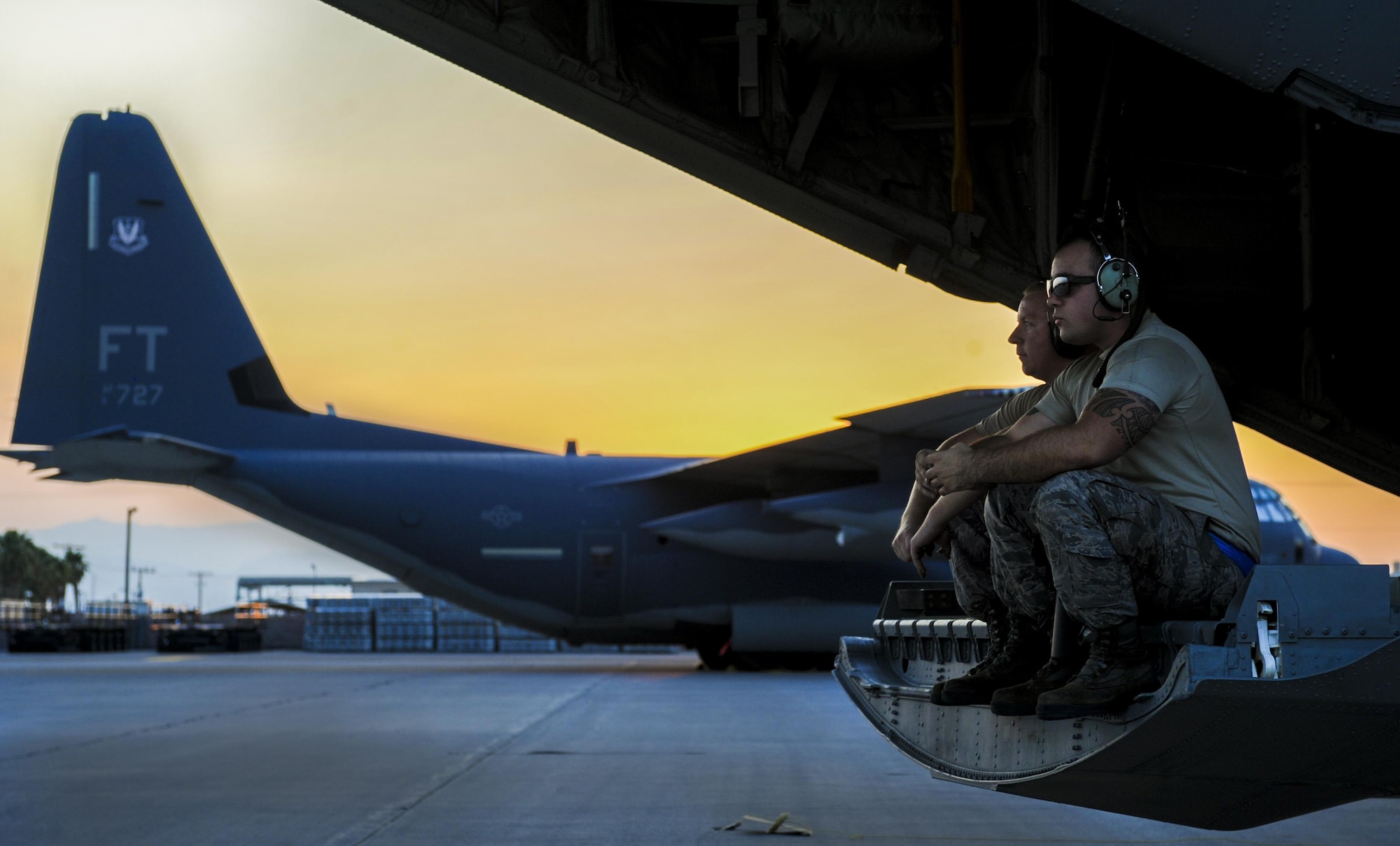 Crew Chiefs assigned to the 71st Rescue Squadron, Moody Air Force Base, Georgia, sit on the back of a HC-130J Combat King II and await aircrew’s arrival during Red Flag 16-4 at Nellis Air Force Base, Nev., Aug. 25, 2016. Aircraft and personnel deploy to Nellis AFB for Red Flag under the Air Expeditionary Force concept and make up the exercise’s “blue” forces. (U.S. Air Force photo by Airman 1st Class Kevin Tanenbaum/Released)